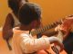 child learning guitar